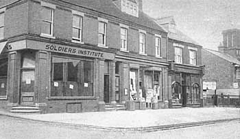 c 1914-1918. Soldiers Institute, Gilbys Drapers & Moss's Grocers.